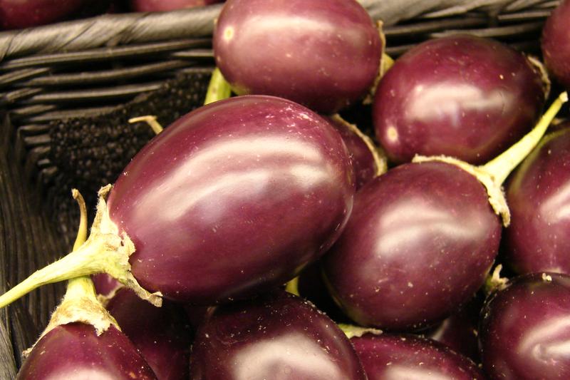 Aubergine is a tender perennial vegetable grown as an annual in the UK, producing glossy purple, white, or striped fruits on bushy plants with
